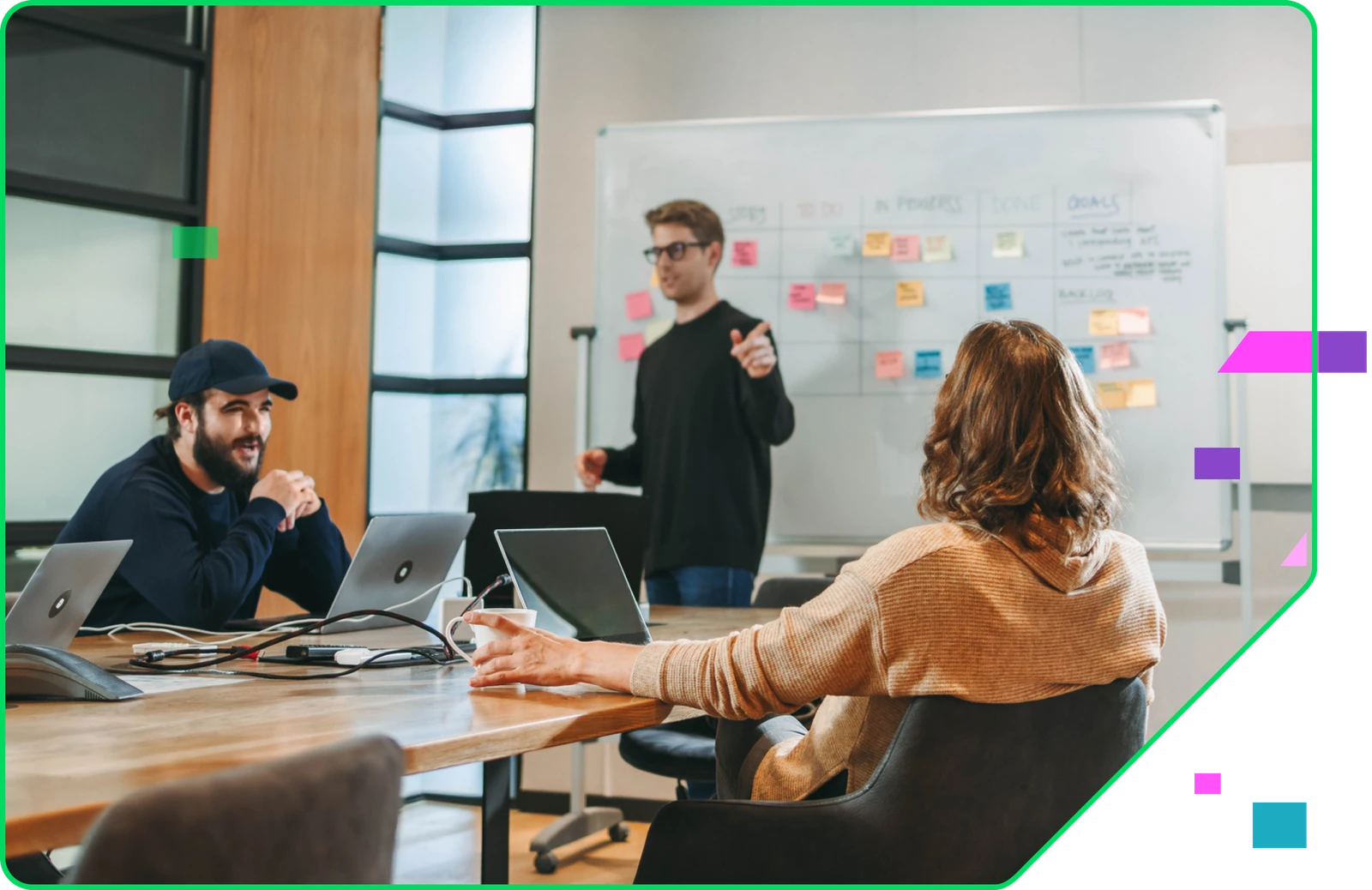 Three Intercept team members in a working session at a whiteboard of sticky notes