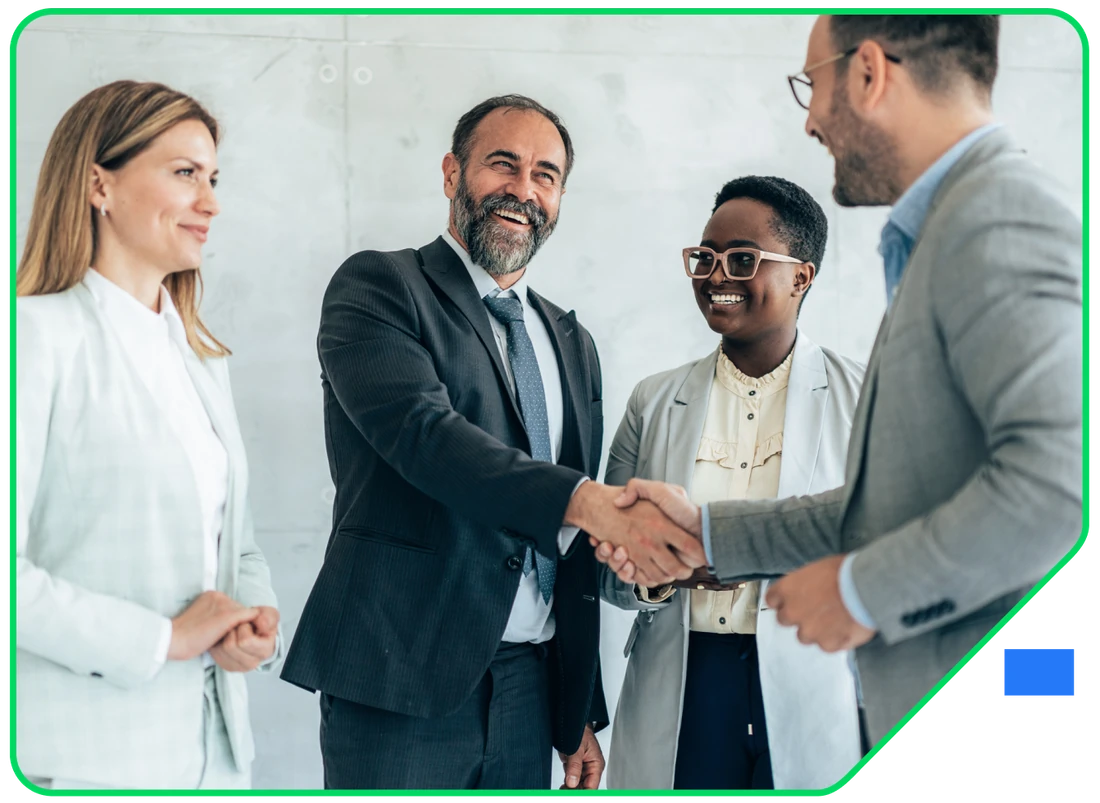 Colleagues shaking hands with a client at the end of a meeting