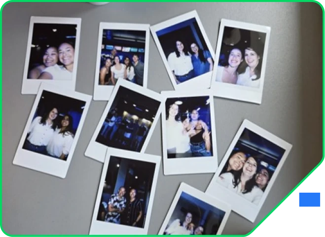 Instant photos from a team night out spread across a desk